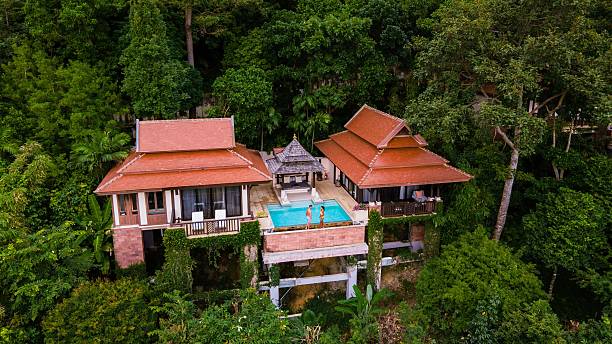 istock Serene tropical retreat featuring luxurious villas and a private pool amidst lush greenery 2212555217