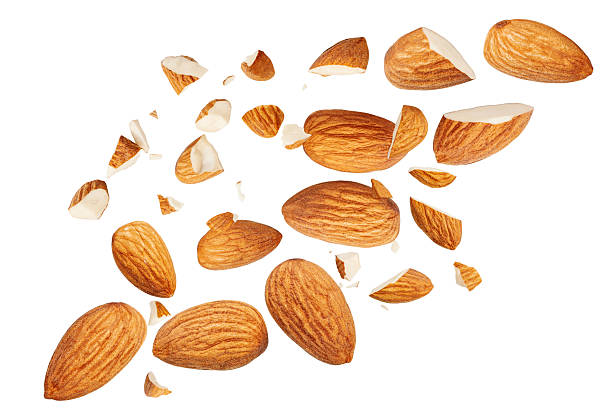 istock Almond nuts  levitating in air isolated on white.  Falling crushed almonds nuts. Cracked Almonds is torn to pieces explosion with crumbs. Food Package design elements 2212555832