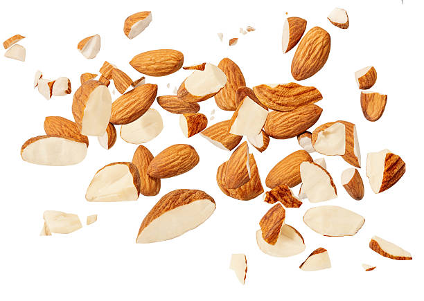 istock Almond nuts  levitating in air isolated on white.  Falling crushed almonds nuts. Cracked Almonds is torn to pieces explosion with crumbs. Food Package design elements 2212555837