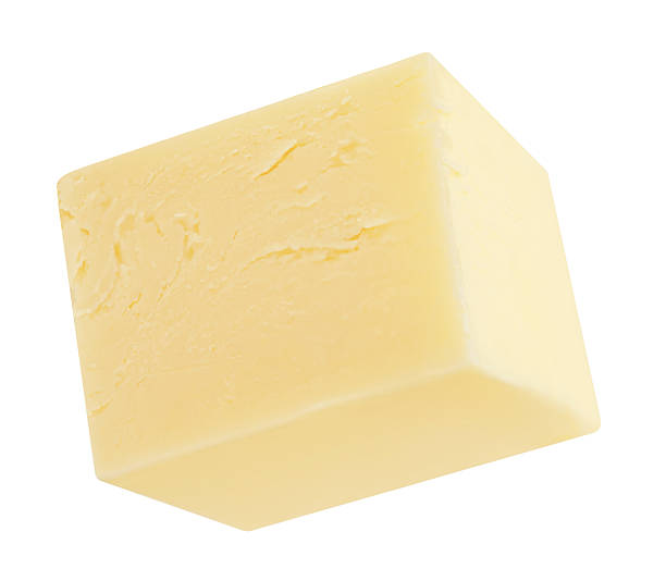 istock Butter cube isolated on white background. Fresh cow's milk butter piece close up. Package design element. 2212556096
