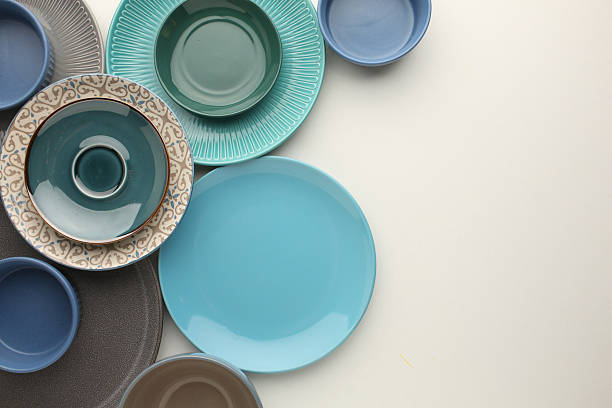 istock Beautiful multi-coloured bright ceramic bowl and tarenes, on a table top view 2212556172