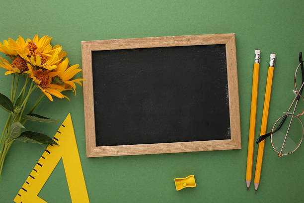 istock Teacher's Day school theme with stationery, chalkboard, and fresh flowers 2212556321