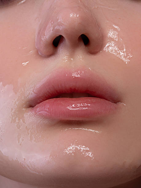 istock Close-up of lips and skin with a glossy hydrating effect 2212556422