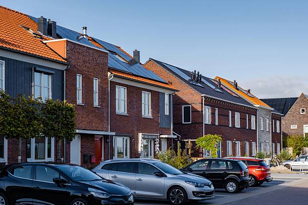istock Modern energy-efficient homes with solar panels lining the streets on a sunny day 2212557241