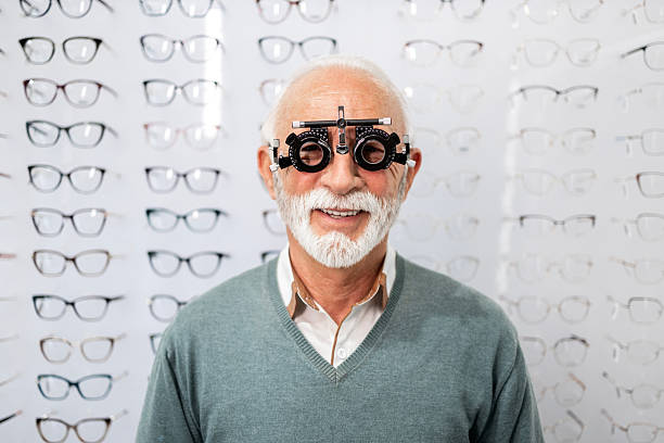 istock Senior man testing diopter in eye health clinic. 2212557315