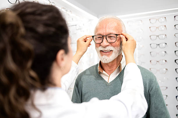 istock Buying new eyeglasses with help of female optometrist. 2212558096