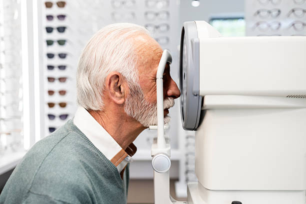 Senior man checking eye health.