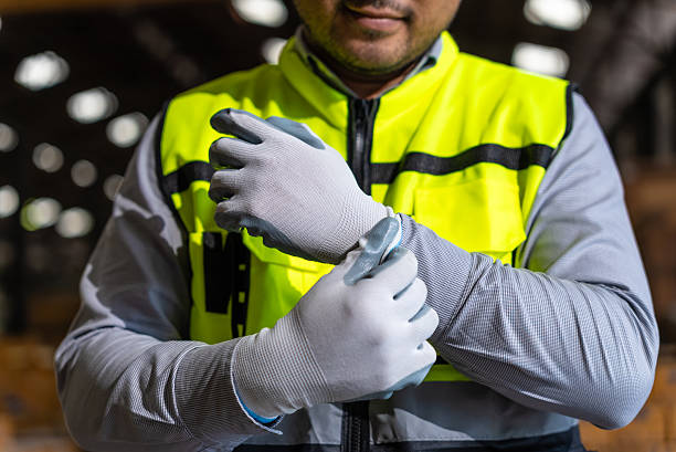 istock Close up asian man technician engineer wearing and adjust protective safety glove. Safety equipment for industry factory. Safety at work concept. 2212559113
