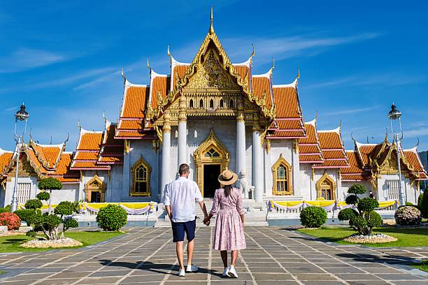 istock Couples explore Wat Benchamabophit, the stunning Marble Temple in Bangkok 2212559312