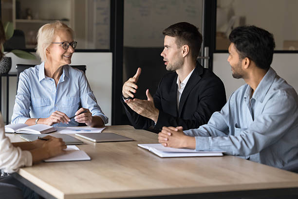 istock Young business professional man speaking at board meeting 2212559589