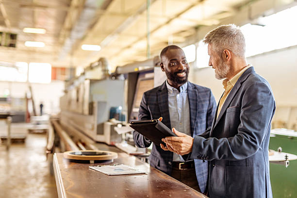 istock Two Professionals Collaborating in a Modern Industrial Environment 2212560214