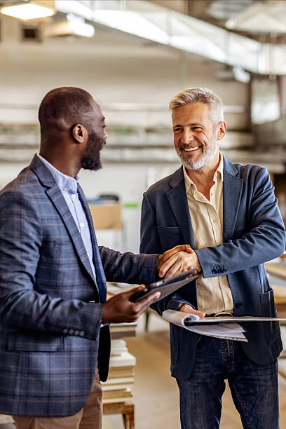 Two Business Professionals Shaking Hands in a Friendly Office Setting