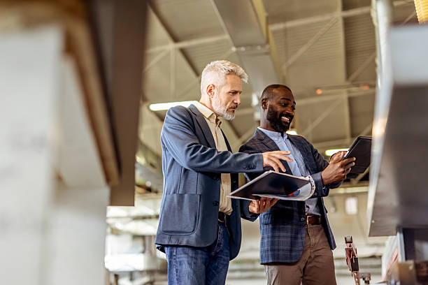 istock Two Professionals Collaborating on a Project in an Industrial Setting 2212560675