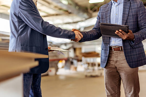 istock Business Professionals Shaking Hands in a Modern Industrial Workplace Environment 2212560677