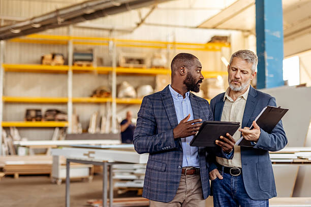 istock Two Businessmen Discussing Work in an Industrial Warehouse 2212561291