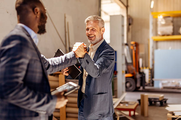 istock Business Professionals Shaking Hands in a Friendly Work Environment 2212562667