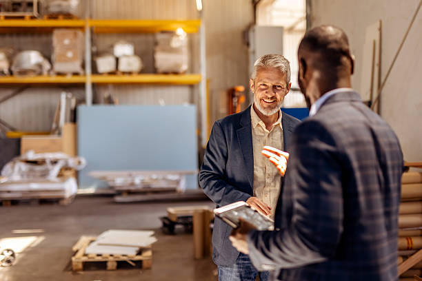 istock Two Businessmen Collaborating in a Warehouse Environment During a Professional Meeting 2212562777