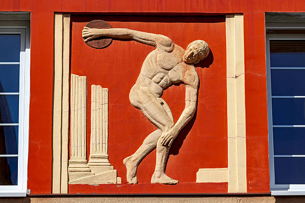 Belgrade, Serbia - March 17, 2023: Ancient Greek Sculpture of Discobolus Discus Thrower Olympics Sport at Red Wall Landmark.
