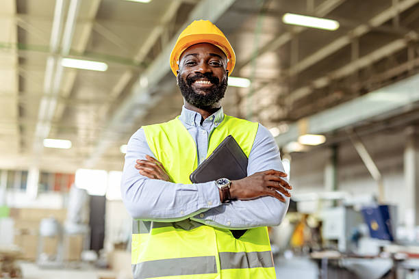 Confident Industrial Engineer at Work Wearing Safety Gear in a Factory Setting