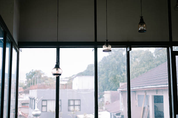 istock Atmospheric urban view through a window with pendant lights hanging 2212564166