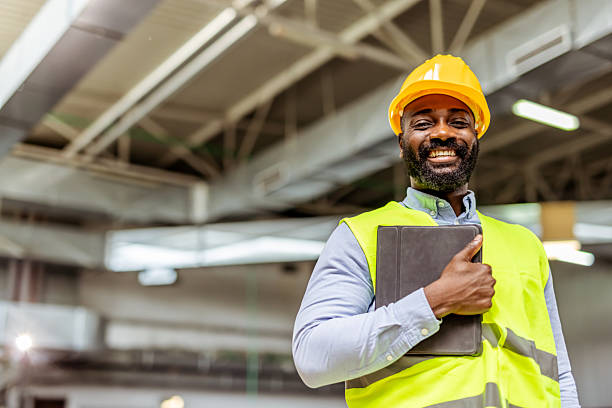 istock Confident Construction Worker in Safety Gear Holding a Tablet Indoors 2212566522