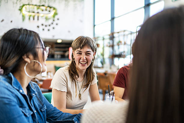 istock Young adults friends enjoying a lively conversation at a restaurant 2212566837