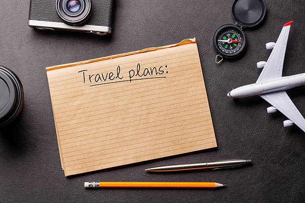 istock Creative flat lay of a travel-themed desk with notepad for plans 2212567147
