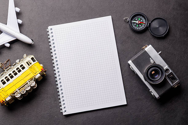 istock Creative flat lay of a travel-themed desk with notepad for plans 2212567156