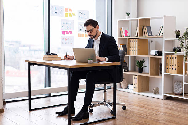 istock Professional man working at desk in modern office space 2212567810