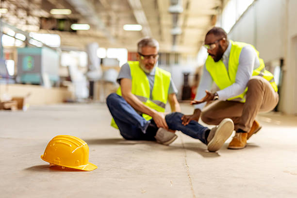 istock Injured Worker Assisted by Colleague in a Construction Site Setting 2212568783
