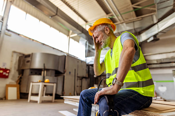 istock Construction Worker Resting in Warehouse with Safety Equipment 2212569853