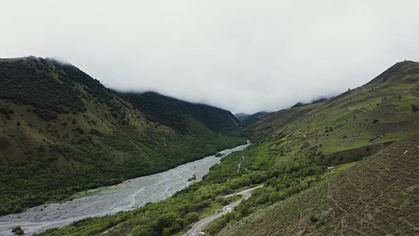 istock The river flows in the lowlands between the green hills 2212571807