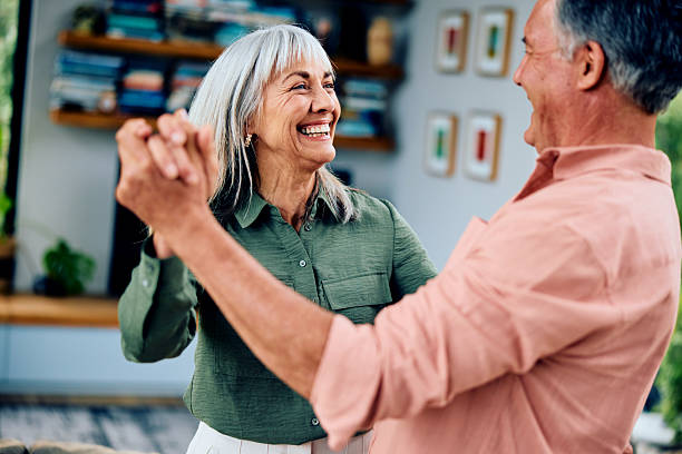 istock Happy senior couple at home dancing and smiling 2212571905