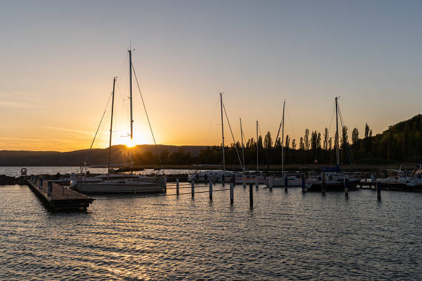 istock Sailboats in a tranquil marina at sunset 2212572172