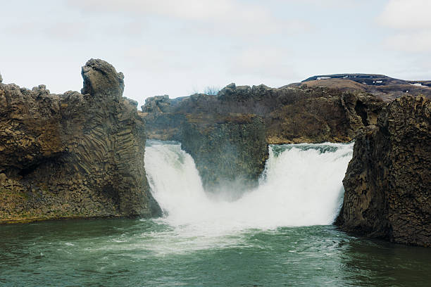 Scenic waterfall hidden in the canyon with basalt columns in South Iceland
