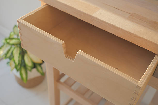 istock An empty wooden drawer set against a serene plant background 2212573162