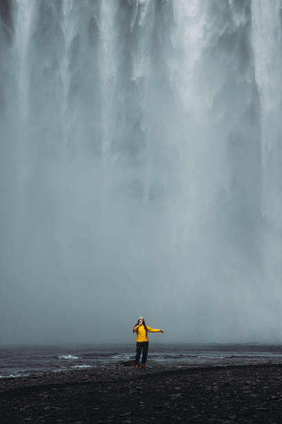 istock Traveller in Distance Making Selfie With Unbelievable Landscape and Waterfall View 2212573538