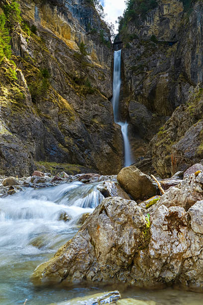 istock Scenic Mountain Waterfall Cascading Through a Rocky Gorge 2212574779
