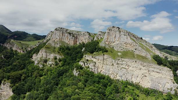 istock Beautiful green mountains, with rocky slopes, covered with dense forest 2212574796