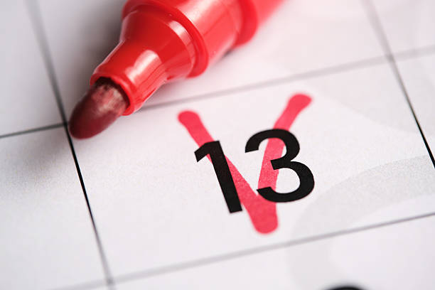 istock 13th day on the calendar is marked with a red marker.Friday the thirteenth. 2212575705