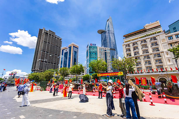 Ho Chi Minh City, Vietnam, April 23rd, 2025. People taking photos and selfies at the Bach Dang Quay Park, decorated for the country’s reunification 50th Anniversary celebrations.
