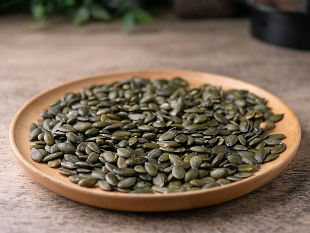 istock Peeled dry pepita pumpkin seeds background. 2212576430