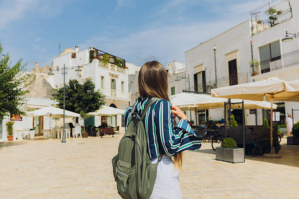 istock Traveller With Backpack Exploring Alberobello City in Italy 2212578442