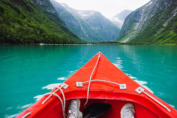 POV of canoeing on turquoise lake with glacier and Mountain View in Jostedalsbreen National park, Norway