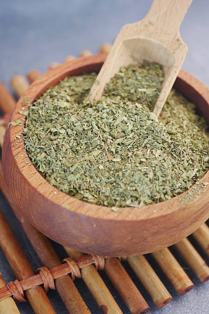 istock A wooden bowl filled with dry oregano 2212582449