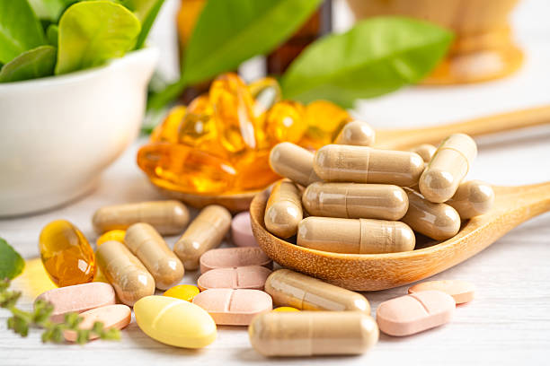istock Alternative medicine herbal organic capsule drug herb. 2212584263