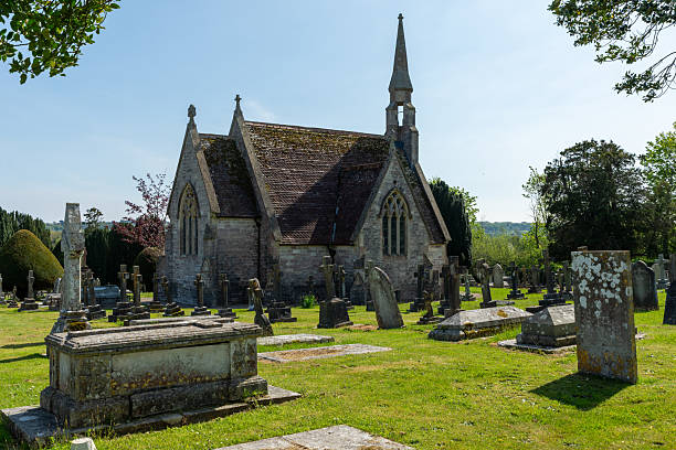 Wimborne Cemetery, Wimborne Minster, UK - April 27th 2025: Graves in front of one of the Grade II listed chapels.