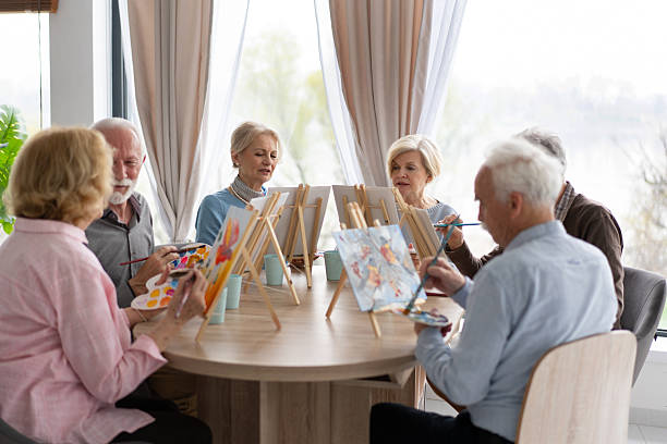 istock Seniors bonding over a communal painting experience 2212586882