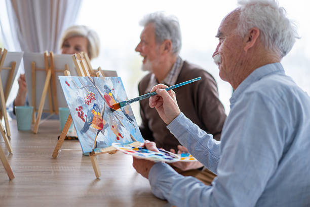 istock Elderly Man Painting Vibrantly with Joyful Expression 2212586894