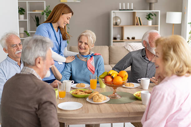 istock Engaging Gathering with Seniors and Caregiver in Bright Room 2212586921